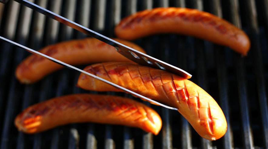 Hold øje med grillpølserne, så de ikke bliver brændte. Hvis skaden sker, så sørg for at skrabe den sorte skorpe af inden serveringen. (Foto: Colourbox)